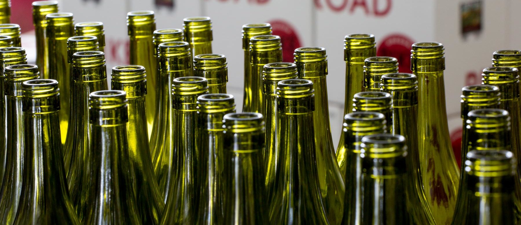 tops of empty wine bottles ready to fill