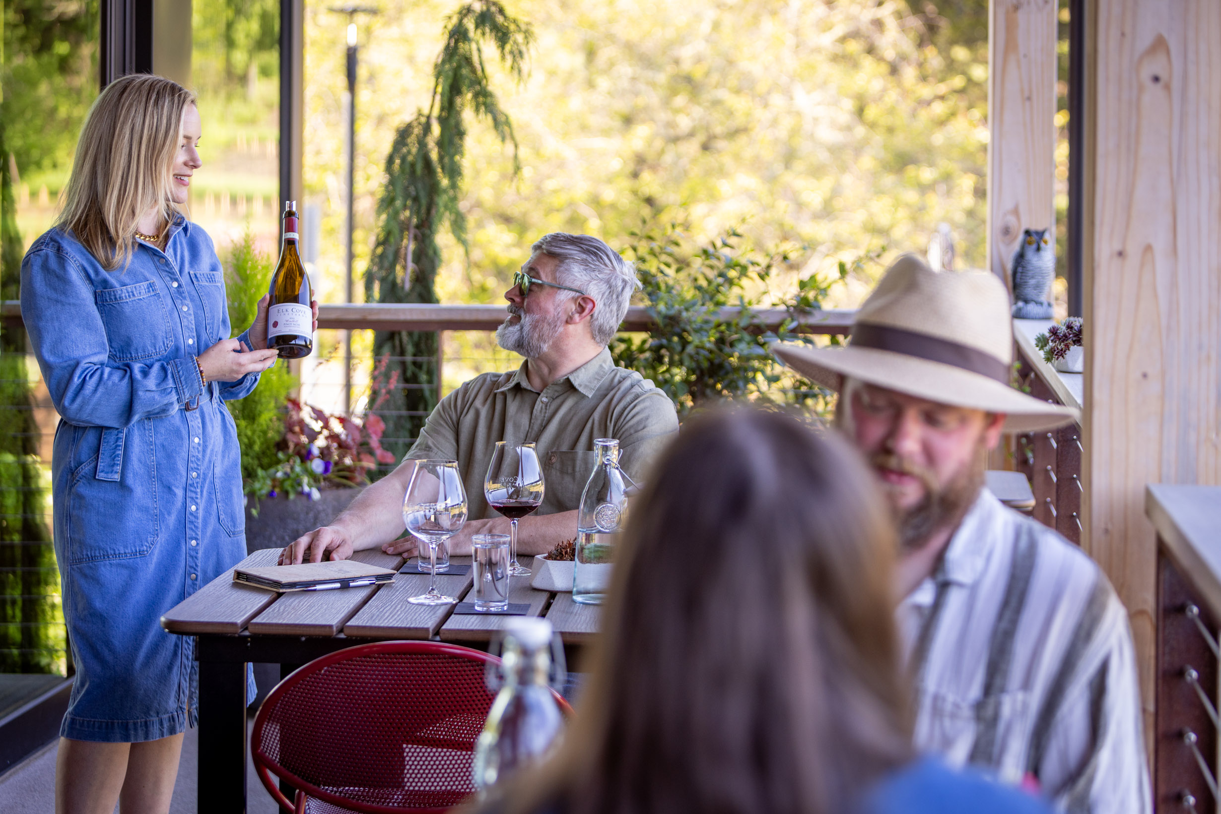 Guests seated on a patio enjoying wine tastings